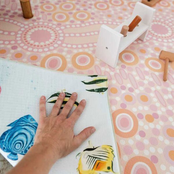 A hands-folding playmat with Reversible design features coral reef